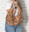 Natural Swirl Cork Crescent Slouchy Shoulder Bag in hand showing size