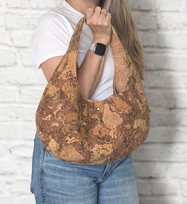 Natural Swirl Cork Crescent Slouchy Shoulder Bag in hand showing size