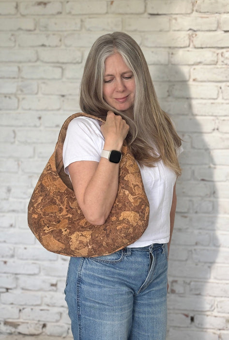 Natural Swirl Cork Crescent Slouchy Shoulder Bag worn on shoulder showing fit and size