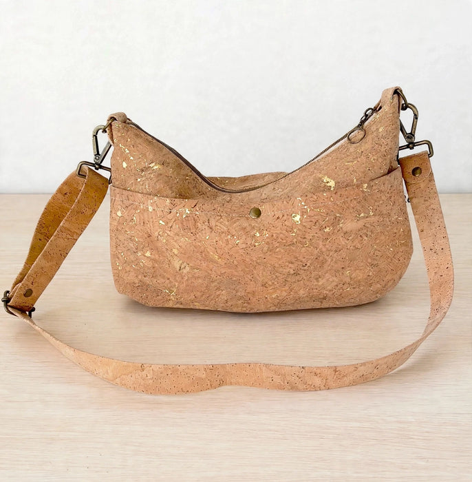 Back of medium gold fleck cork crossbody bag with exterior slip pocket