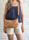Natural Swirl Medium Crossbody Bag worn crossbody with adjustable cork strap
